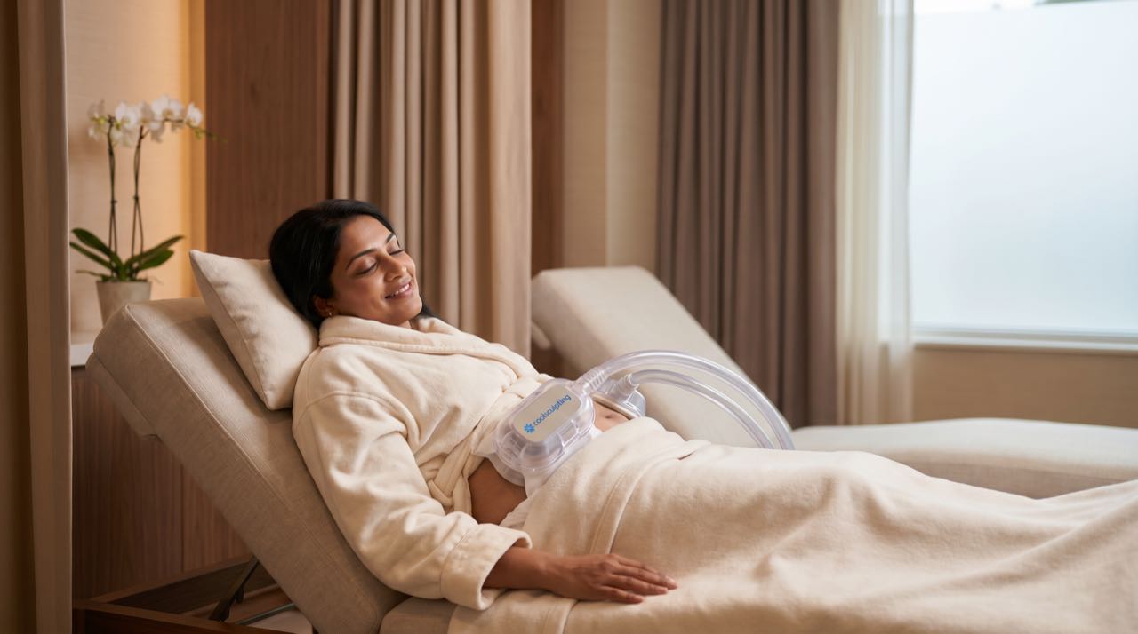 Patient comfortable during a CoolSculpting body contouring session in a warm calm room.